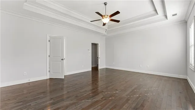 a spacious bathroom with a tub sink and mirror