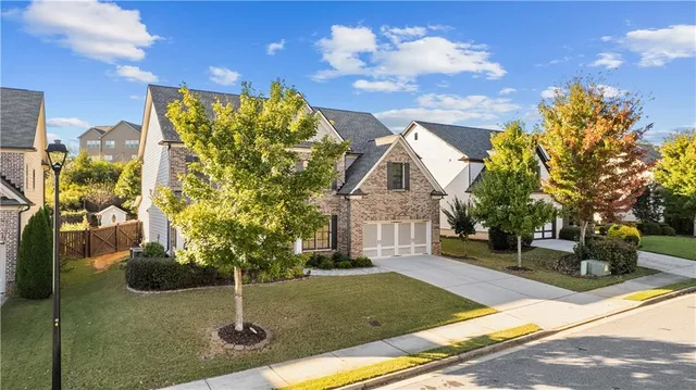 front view of a brick house with a large window