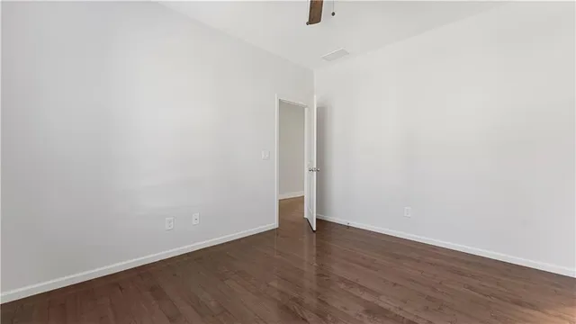 a bathroom with a granite countertop sink a mirror a bathtub and a toilet