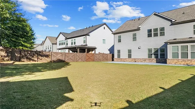 a view of house with backyard