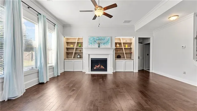 a view of wooden floor and windows in a room