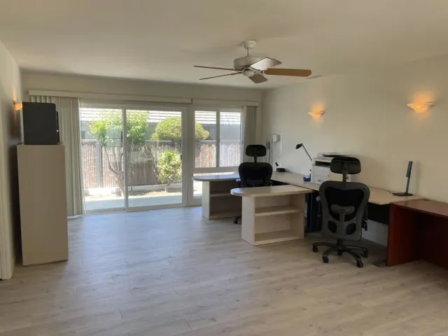 a work space with furniture and a large window