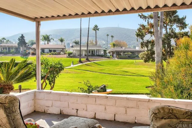 a view of a swimming pool with a yard and sitting area