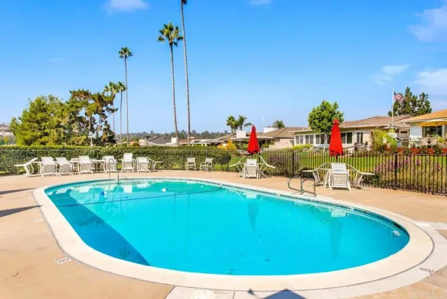 a view of a swimming pool with a lawn chairs