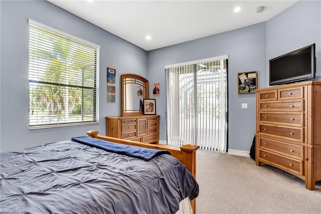 281 19th Street Southwest Naples, FL 34117 - Photo 24 of 35 4th bedroom with sliders out to pool area and a private patio under roof
