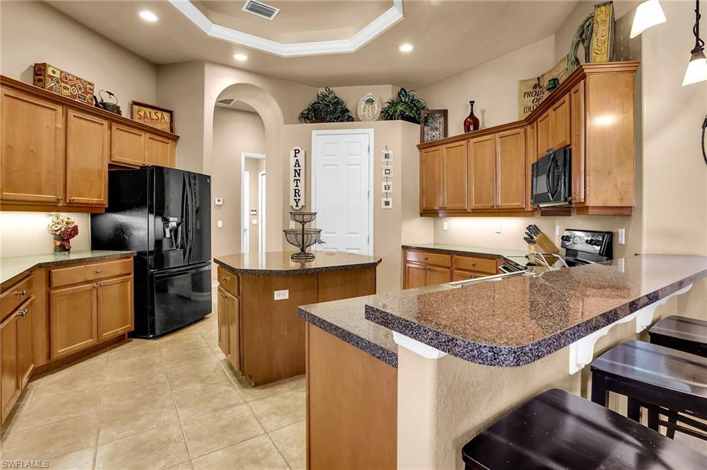 281 19th Street Southwest Naples, FL 34117 - Photo 8 of 35 Kitchen with tons of storage, island with overhang for seating and a walk-in pantry