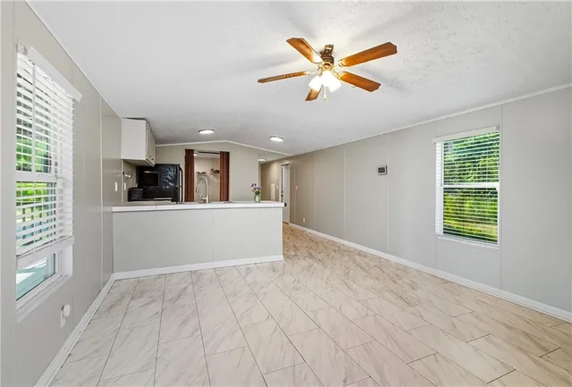 a view of a chandelier fan in a room