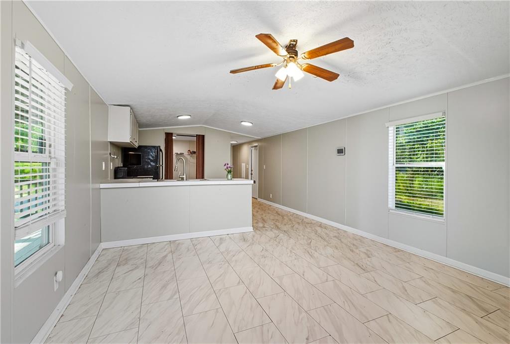 221 McAllister Road Cornelia, GA 30531 - Photo 13 of 58 a view of a livingroom with a ceiling fan and window