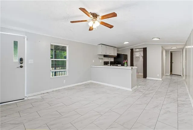 a kitchen with a refrigerator and a stove