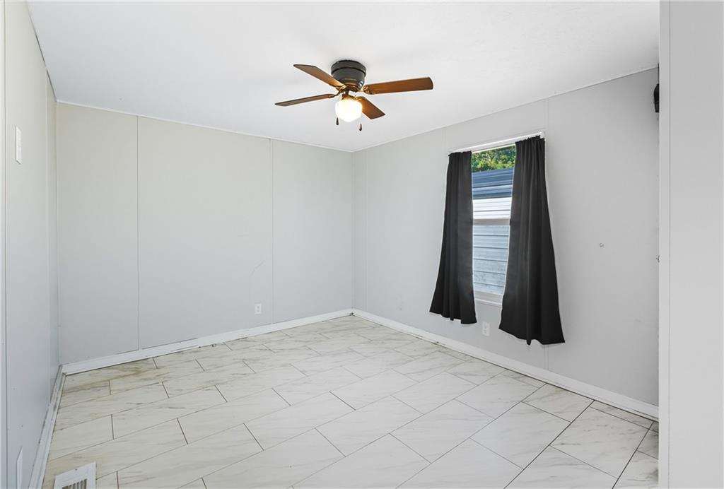 221 McAllister Road Cornelia, GA 30531 - Photo 15 of 58 an empty room with fan and windows