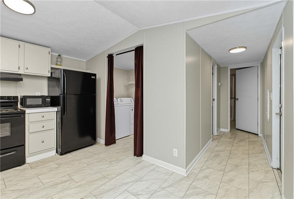 221 McAllister Road Cornelia, GA 30531 - Photo 18 of 58 a view of a kitchen with refrigerator and white cabinets