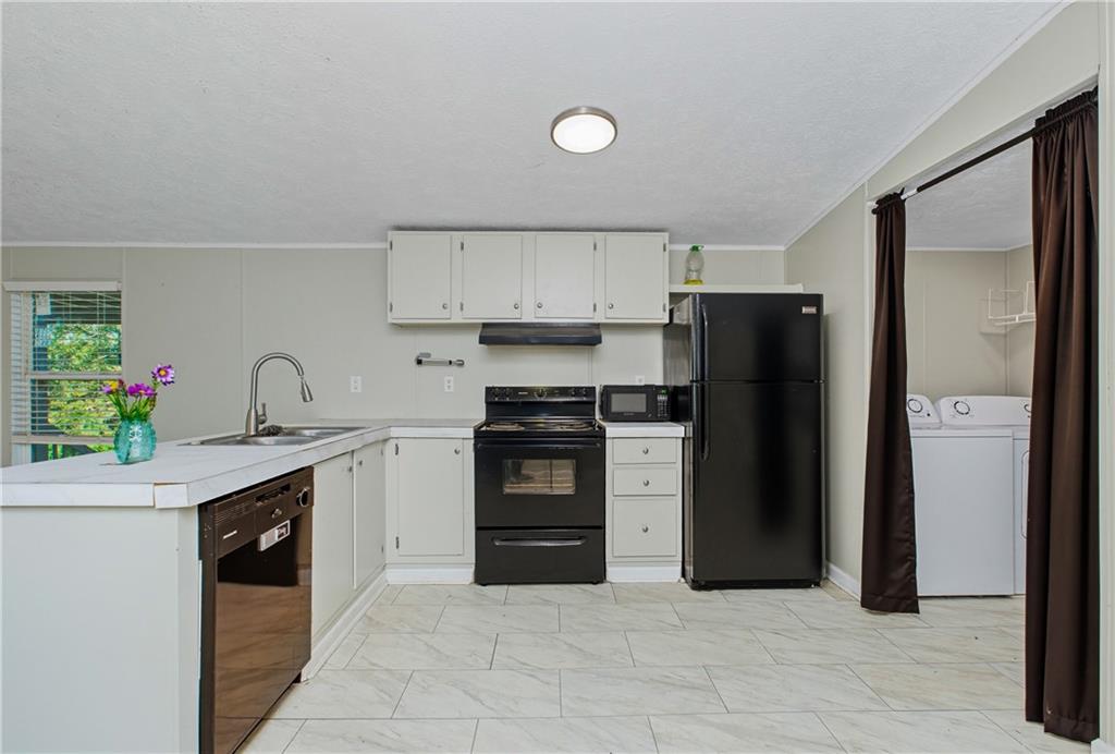 221 McAllister Road Cornelia, GA 30531 - Photo 19 of 58 a kitchen with stainless steel appliances granite countertop a refrigerator sink and stove