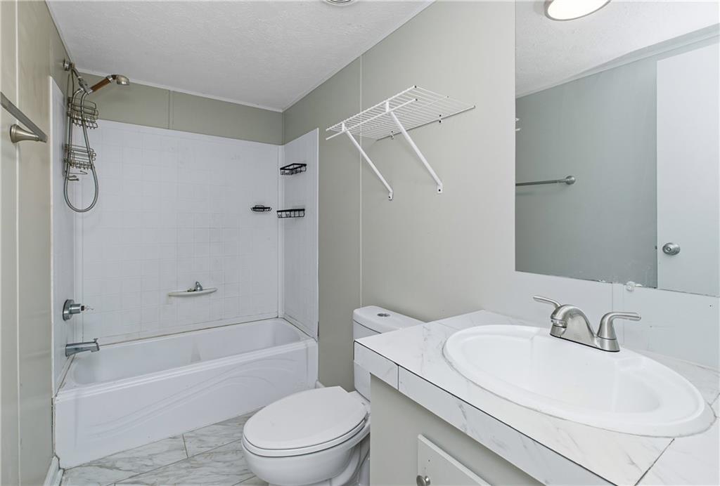 221 McAllister Road Cornelia, GA 30531 - Photo 22 of 58 a bathroom with a granite countertop sink toilet and shower