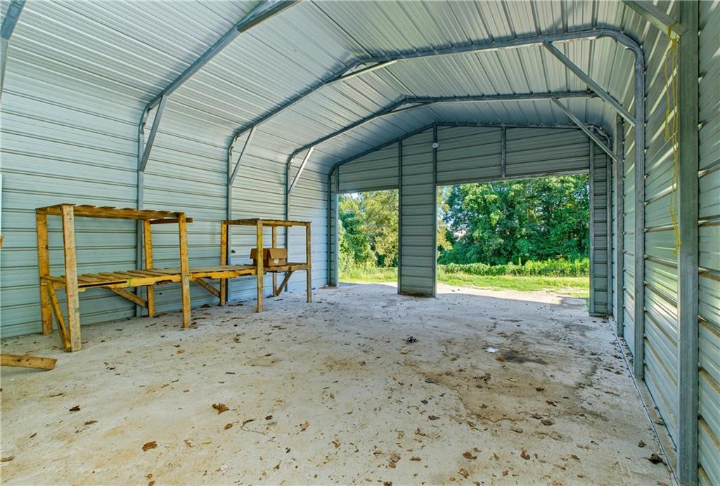 221 McAllister Road Cornelia, GA 30531 - Photo 28 of 58 a view of a backyard with a table and chairs under an umbrella