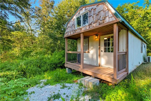 a view of a hallway with wooden floor and a ceiling fan