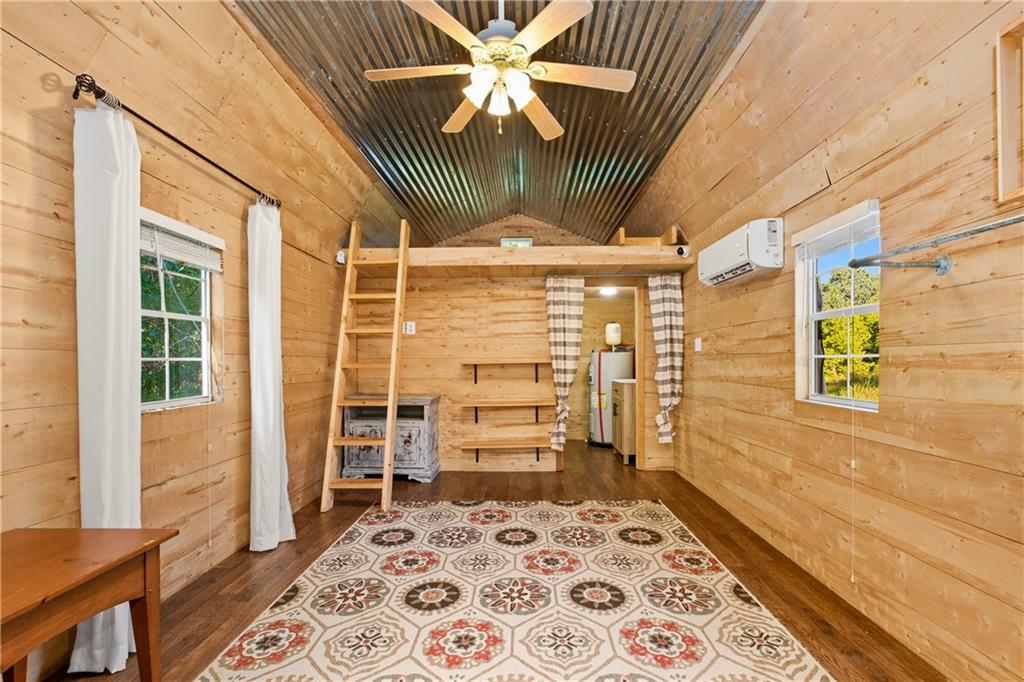 221 McAllister Road Cornelia, GA 30531 - Photo 36 of 58 a view of a hallway with wooden floor and a ceiling fan