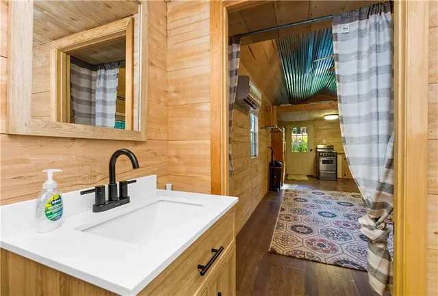 a kitchen with a stove a sink and a window