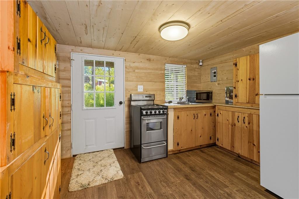221 McAllister Road Cornelia, GA 30531 - Photo 43 of 58 a kitchen with a stove a sink and a refrigerator