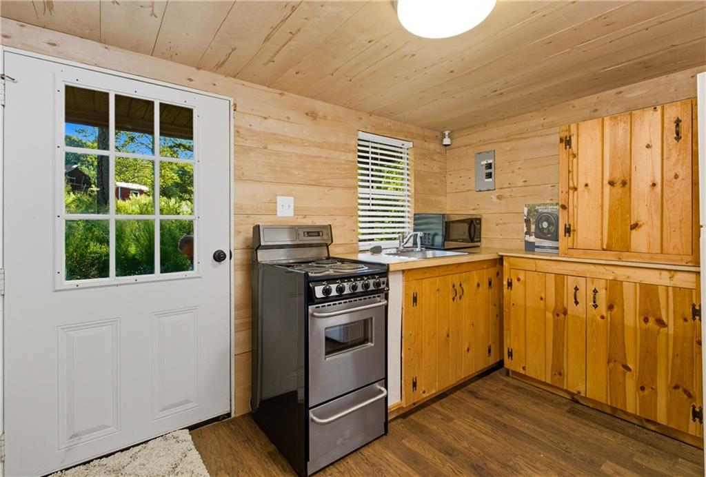 221 McAllister Road Cornelia, GA 30531 - Photo 44 of 58 a kitchen with a stove a sink and a window