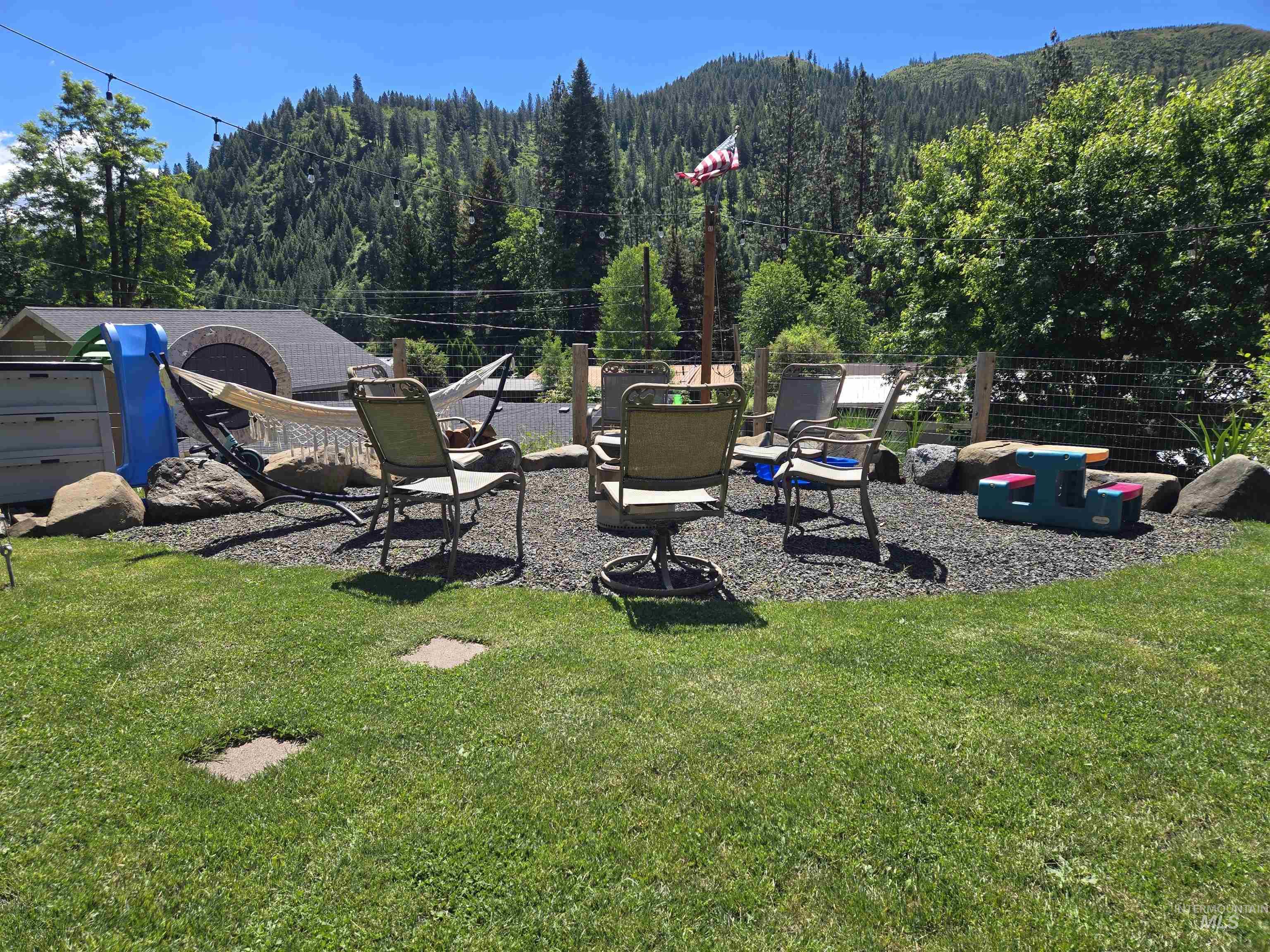 174 Konkolville Road Orofino, ID 83544 - Photo 37 of 43 Expansive green lawn with stepping stones leading to a dedicated gravel patio area