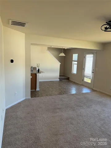 a view of a big room with windows and chandelier