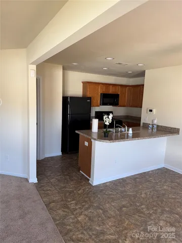 a kitchen with stainless steel appliances a refrigerator and a stove