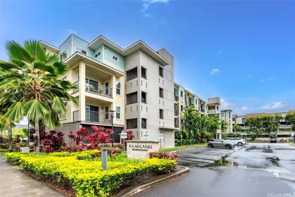 a view of a building with a yard and sitting area