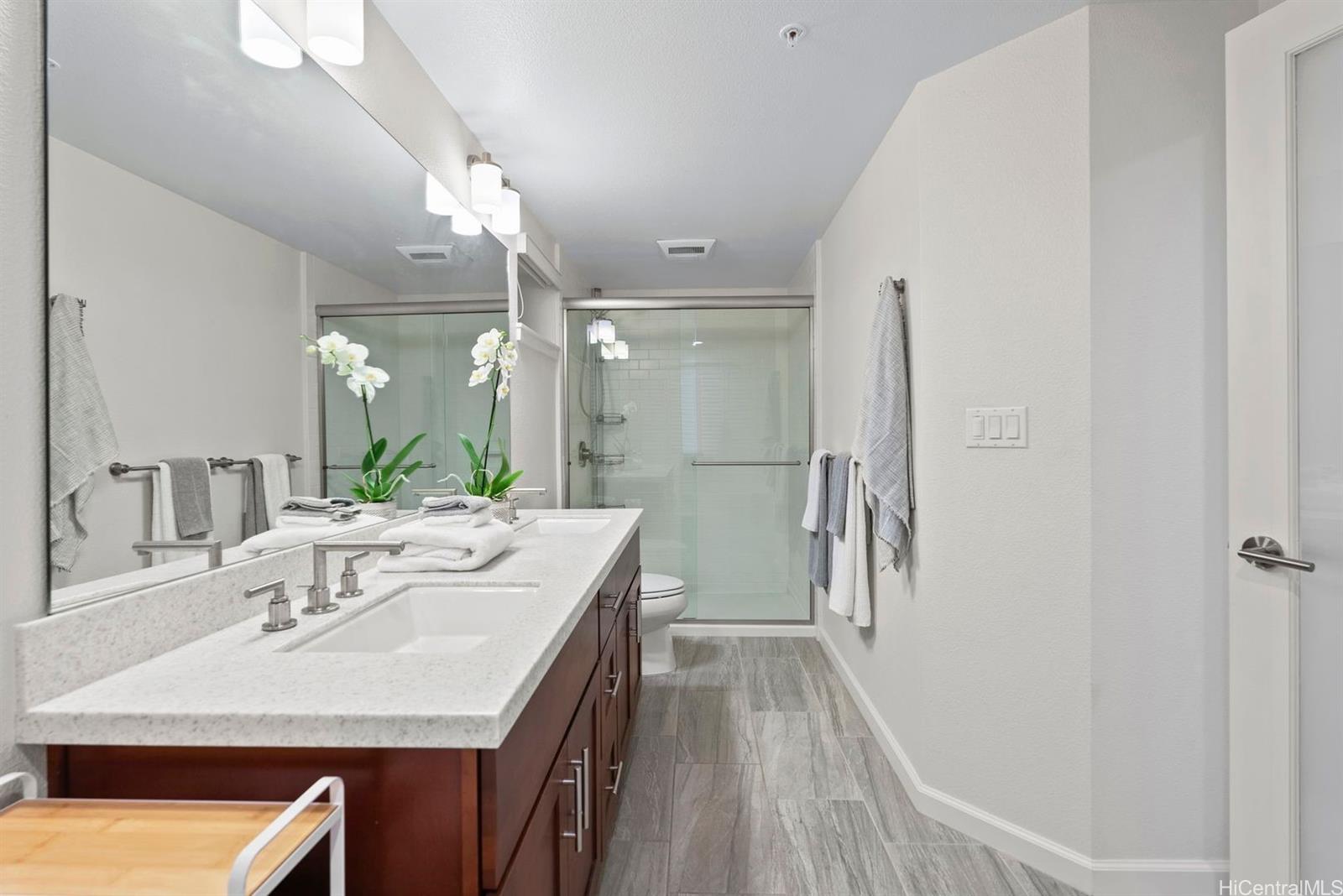 361 Kailua Road, Unit RD8205 Kailua, HI 96734 - Photo 17 of 23 a bathroom with a sink a toilet a mirror and shower