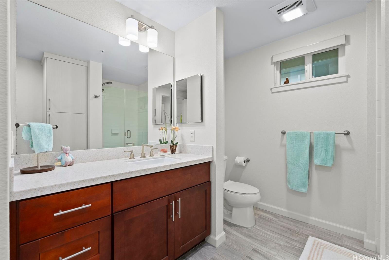 361 Kailua Road, Unit RD8205 Kailua, HI 96734 - Photo 22 of 23 a spacious bathroom with a sink a toilet a shower and a mirror