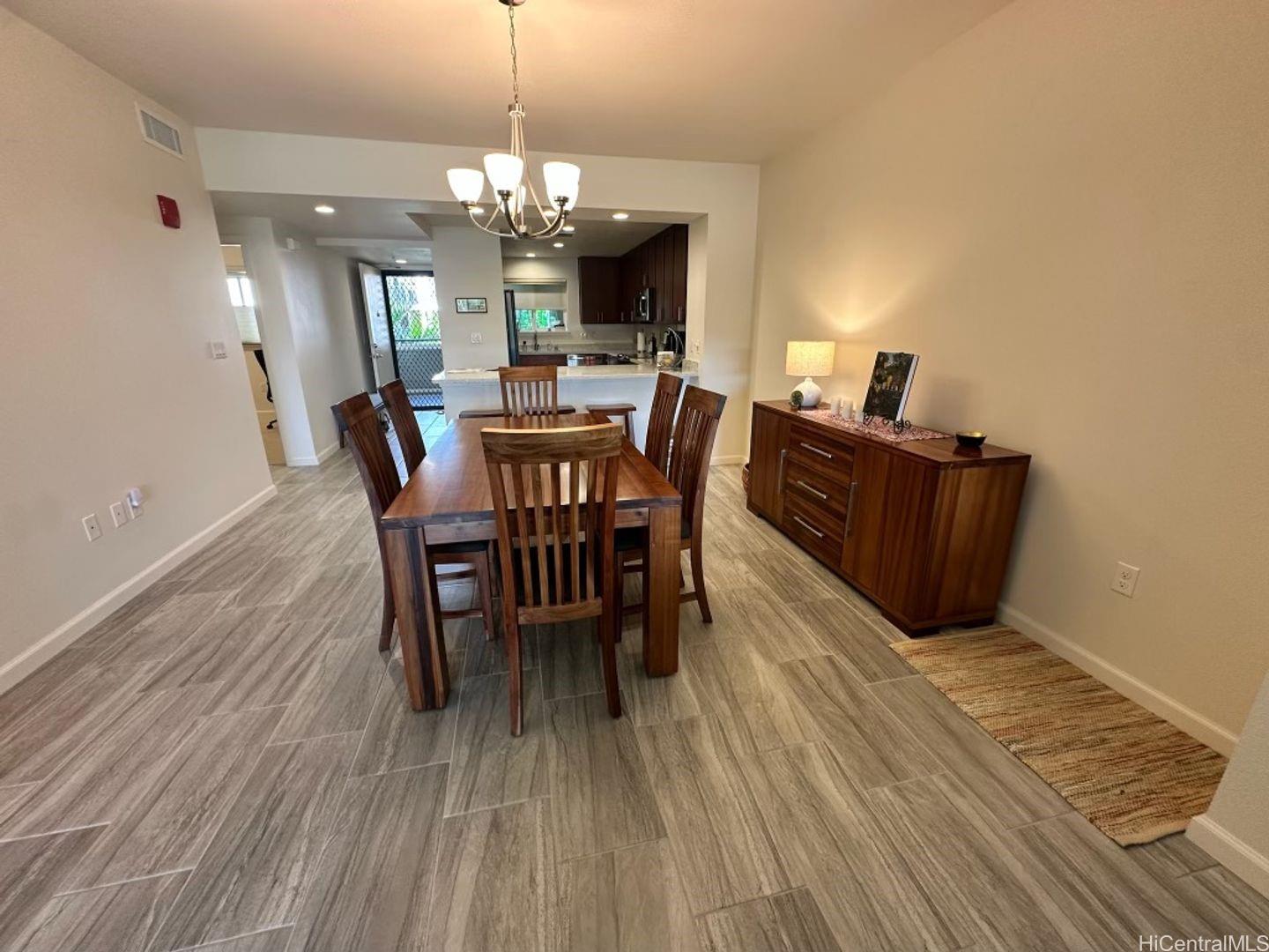 361 Kailua Road, Unit RD8205 Kailua, HI 96734 - Photo 7 of 23 a view of a dining room with furniture and wooden floor