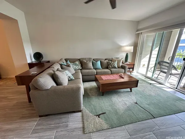 a living room with furniture and a floor to ceiling window