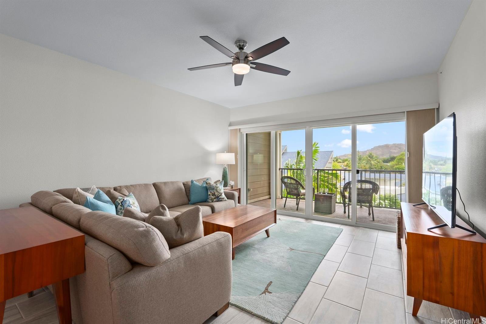 361 Kailua Road, Unit RD8205 Kailua, HI 96734 - Photo 9 of 23 a living room with furniture and a flat screen tv with a large window