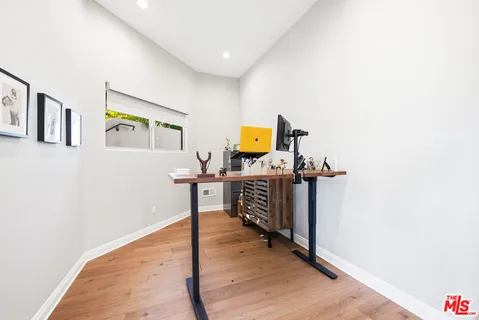 a view of a workspace with wooden floor