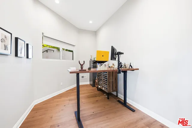 a view of a workspace with wooden floor