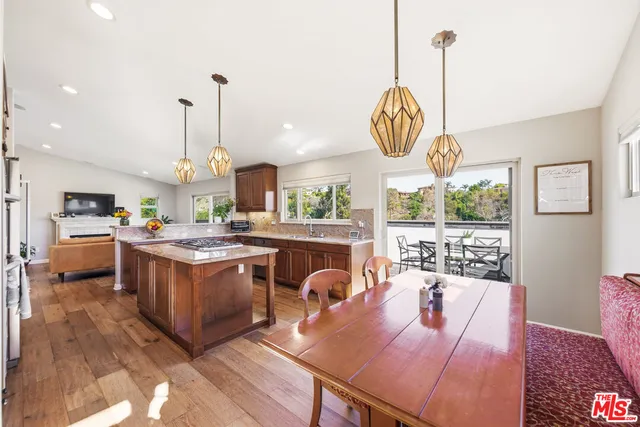 a open kitchen with granite countertop a stove and white cabinets
