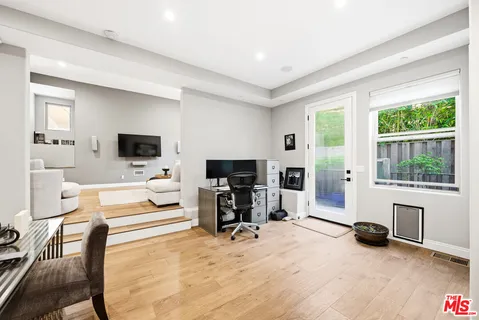 a living room with furniture gym equipment and a window