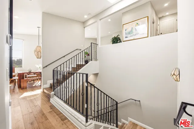 a view of staircase with wooden floor and next to a window