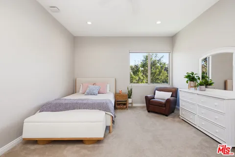 a spacious bedroom with a bed and a couch