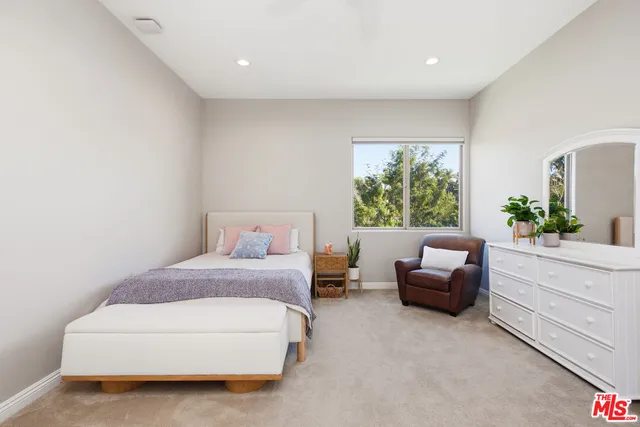 a spacious bedroom with a bed and a couch