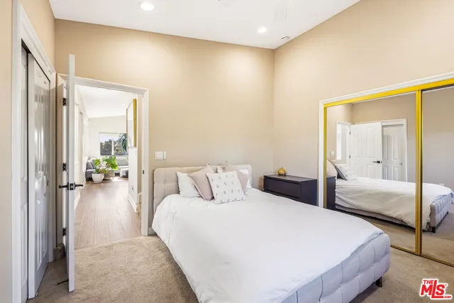 a bedroom with a bed and a mirror