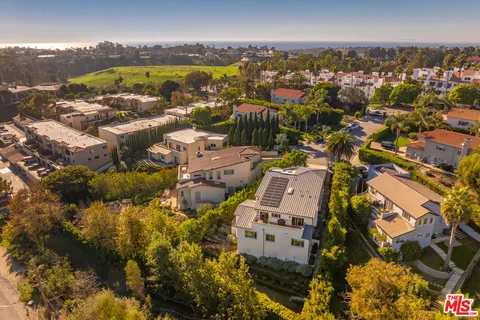 an aerial view of residential building with swimming pool and mountain view
