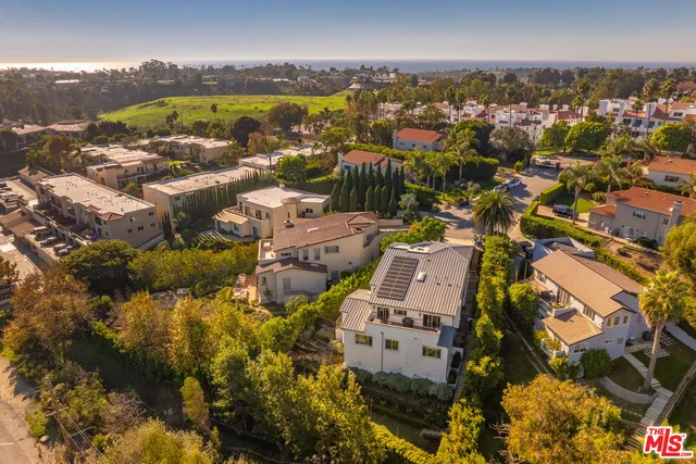 an aerial view of residential building with swimming pool and mountain view