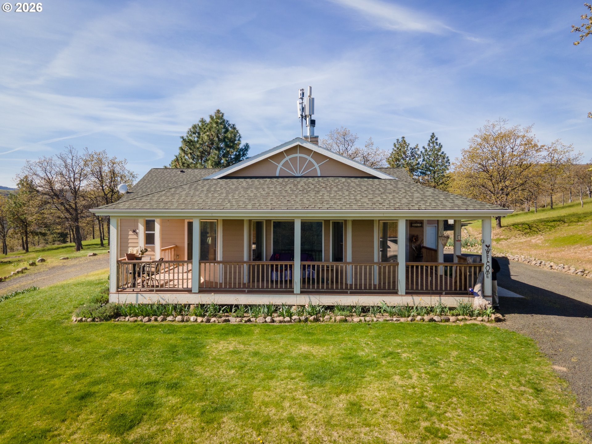 4377 Browns Creek Road The Dalles, OR 97058 - Photo 23 of 38 a front view of a house with a yard table and chairs