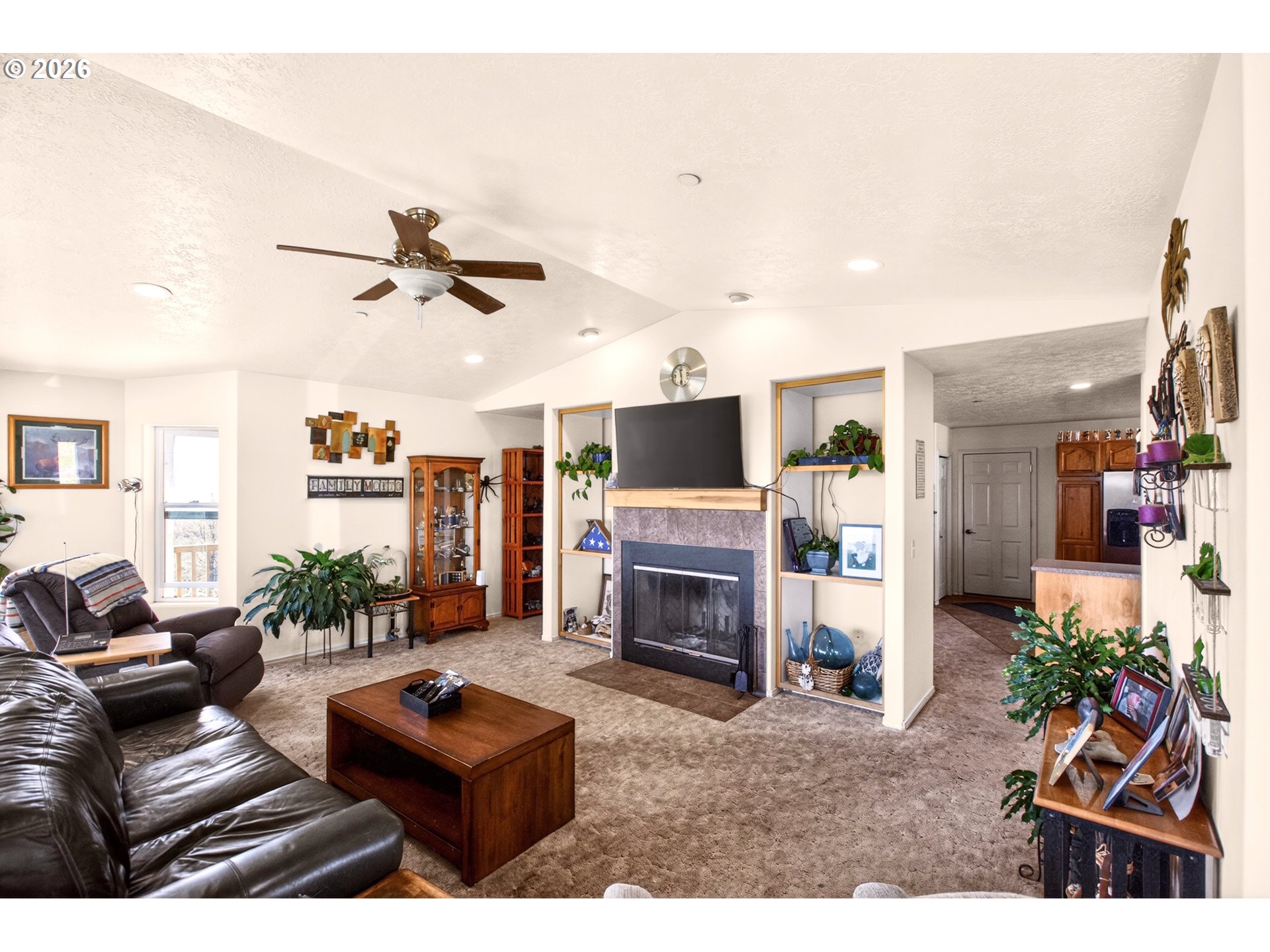 4377 Browns Creek Road The Dalles, OR 97058 - Photo 5 of 38 a living room with furniture a fireplace and a flat screen tv