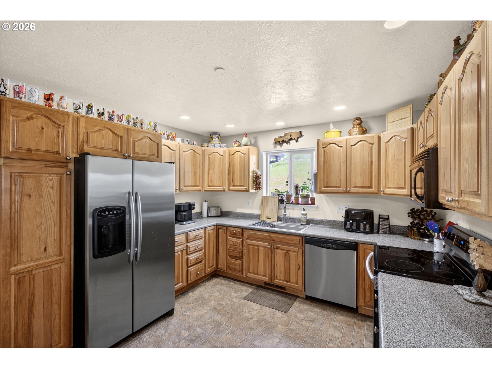 4377 Browns Creek Road The Dalles, OR 97058 - Photo 7 of 38 a kitchen with stainless steel appliances a sink a stove a refrigerator cabinets and a window