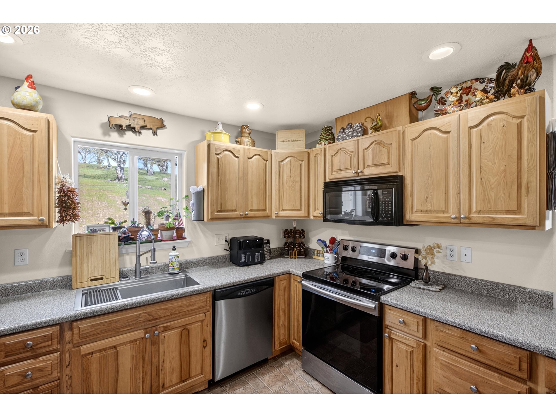 4377 Browns Creek Road The Dalles, OR 97058 - Photo 8 of 38 a kitchen with stainless steel appliances granite countertop a sink a stove a microwave a refrigerator and cabinets