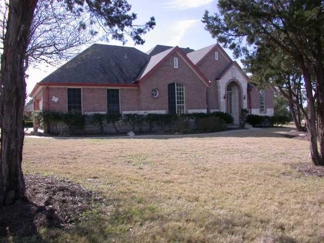 295 Tom Sawyer Road Austin, TX 78737 - Photo 1 of 1 a front view of a house with a yard