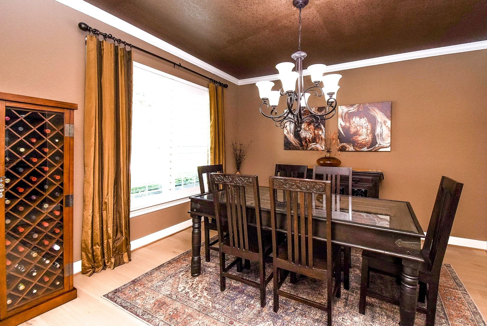 27607 Macklind Ridge Lane Katy, TX 77494 - Photo 16 of 50 Formal dining room with crown molding, oil rub bronzed light fixture, plantation shutters and engineered wood flooring.