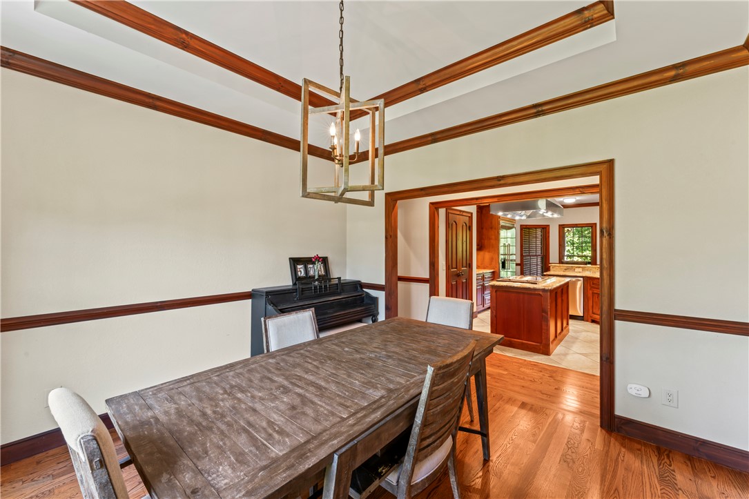 579 Terrapin Crossing Road Pickens, SC 29671 - Photo 14 of 50 Hardwood floors and tray ceiling define this formal dining space, with views into an adjoining kitchen.