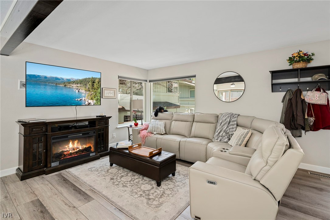 a living room with furniture a fireplace and a window